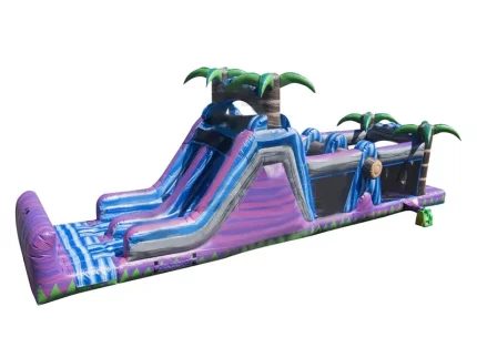 Purple tropical bounce house with dual water slides and palm tree accents, perfect for events. Buy affordable, high-quality inflatables online now!