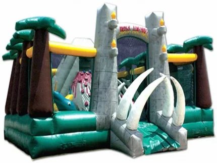 Dinosaur-themed bounce house with palm trees, tusk entrance, and vibrant colors. Perfect for kids' parties. Buy online now for affordable prices!